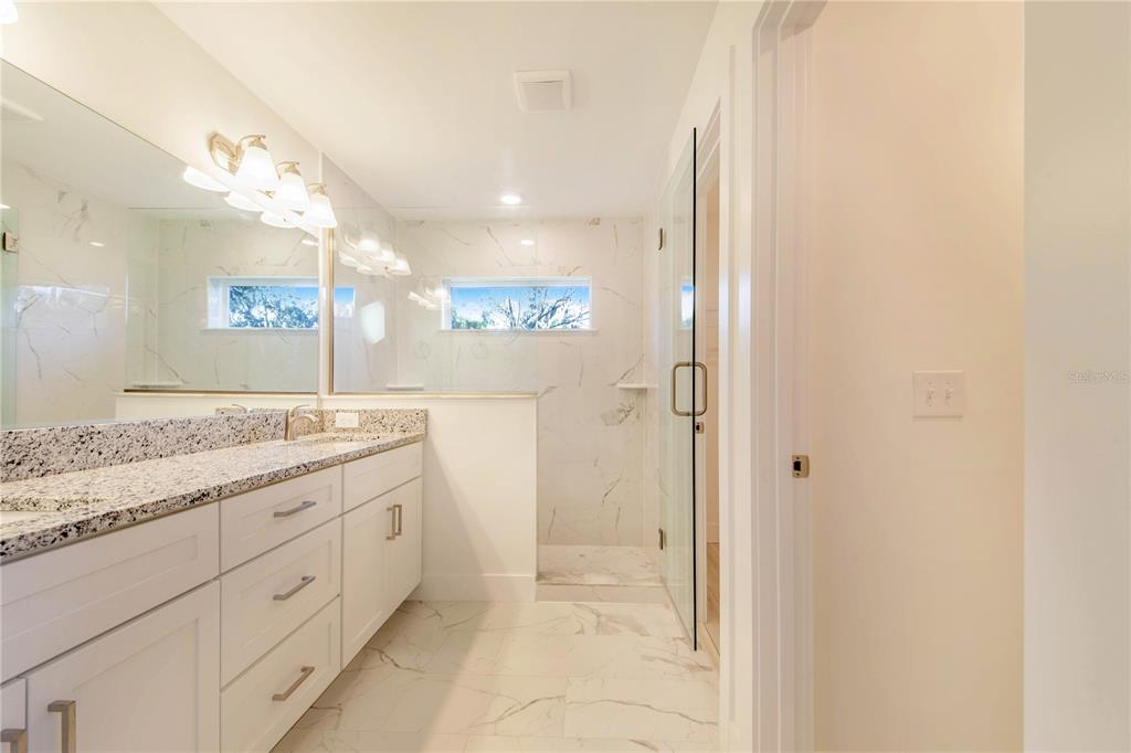 500 9th Street Northeast Fort Meade, FL 33841 - Photo 22 of 33 a bathroom with a granite countertop sink a mirror and a shower