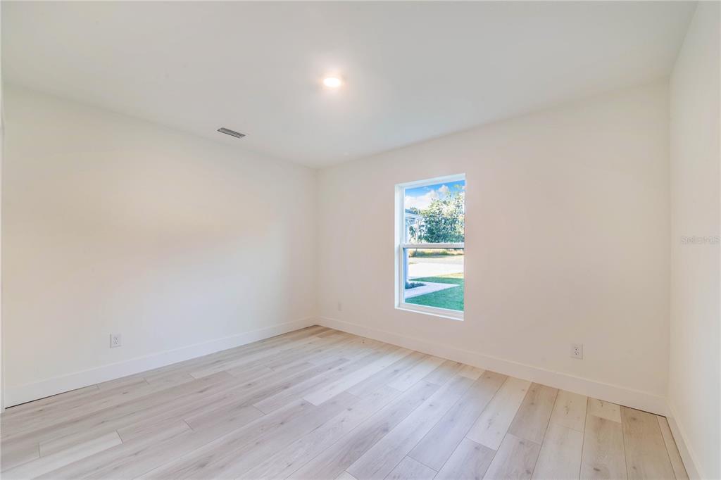 500 9th Street Northeast Fort Meade, FL 33841 - Photo 27 of 33 an empty room with wooden floor and window