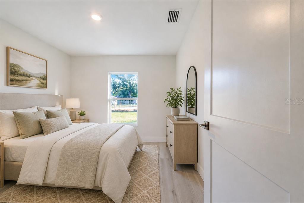 500 9th Street Northeast Fort Meade, FL 33841 - Photo 30 of 33 a spacious bedroom with a bed and a window