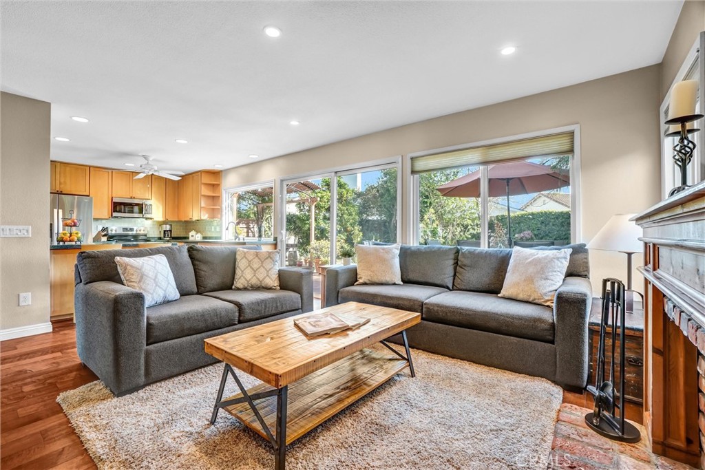 5552 Ridgebury Drive Huntington Beach, CA 92649 - Photo 12 of 31 a living room with furniture wooden floor and a large window