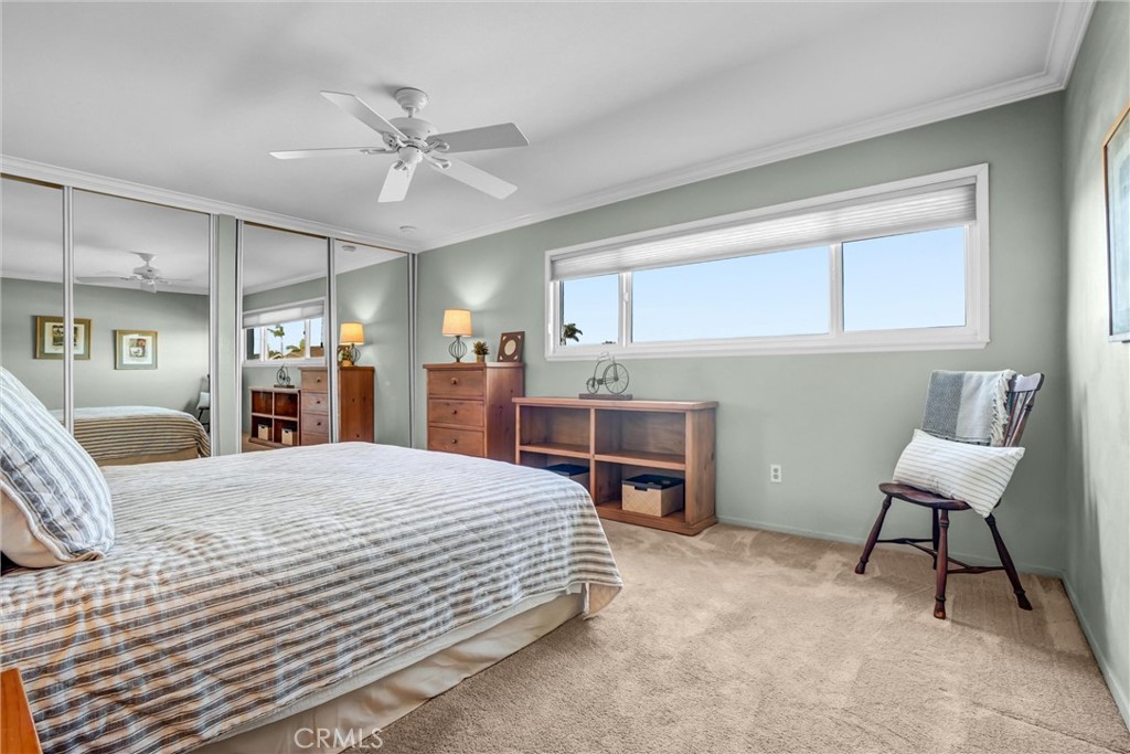 5552 Ridgebury Drive Huntington Beach, CA 92649 - Photo 15 of 31 a bedroom with a bed and a chandelier