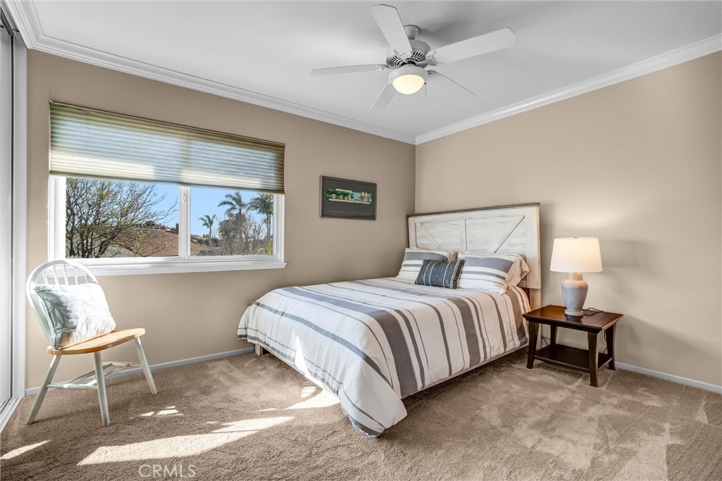 5552 Ridgebury Drive Huntington Beach, CA 92649 - Photo 18 of 31 a spacious bedroom with a bed and a painting on the wall