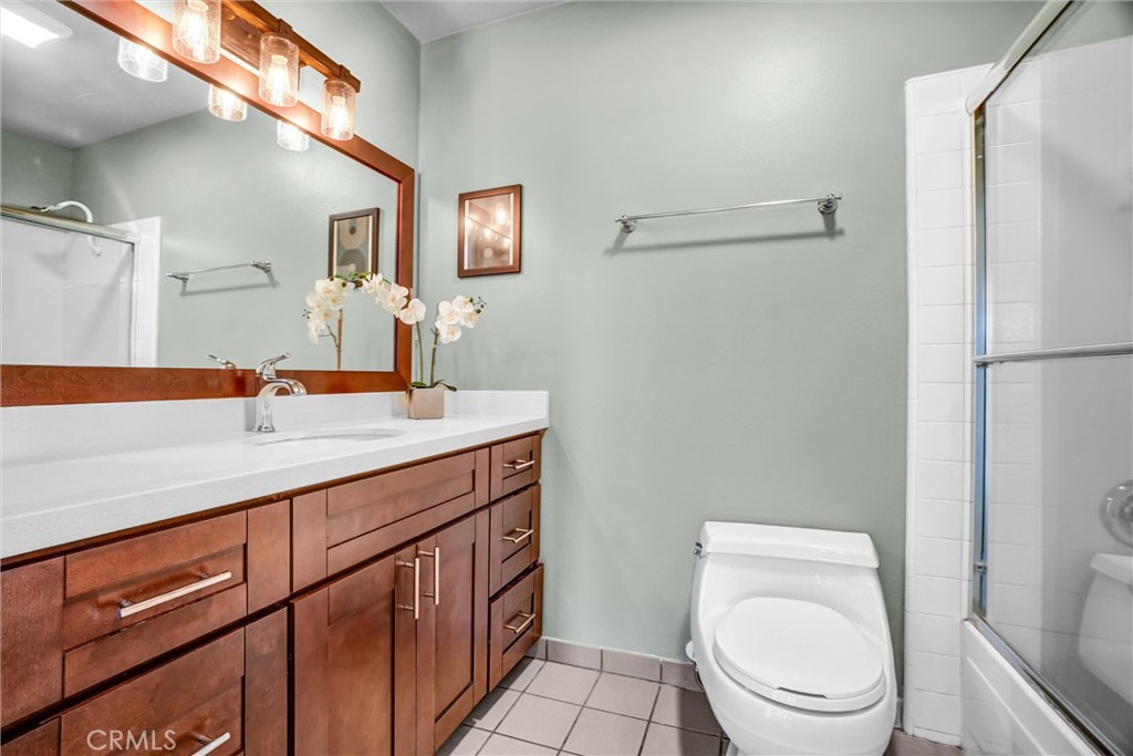 5552 Ridgebury Drive Huntington Beach, CA 92649 - Photo 19 of 31 a bathroom with a toilet a sink and a mirror