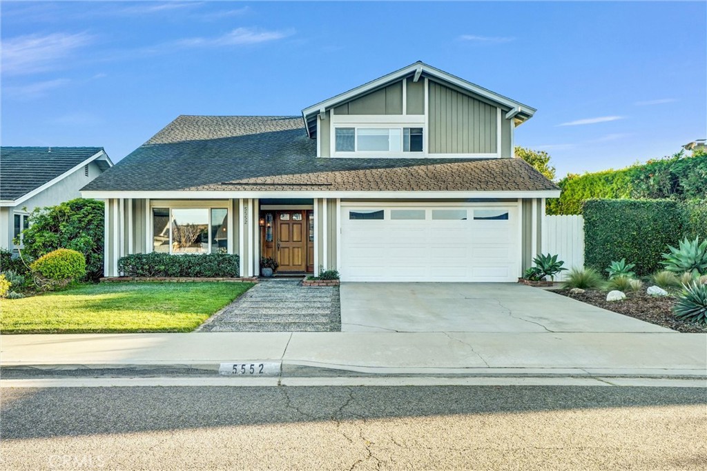 5552 Ridgebury Drive Huntington Beach, CA 92649 - Photo 2 of 31 a front view of a house with a yard and garage