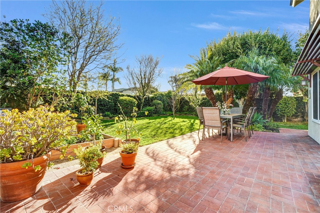 5552 Ridgebury Drive Huntington Beach, CA 92649 - Photo 22 of 31 a view of a table and chairs under an umbrella