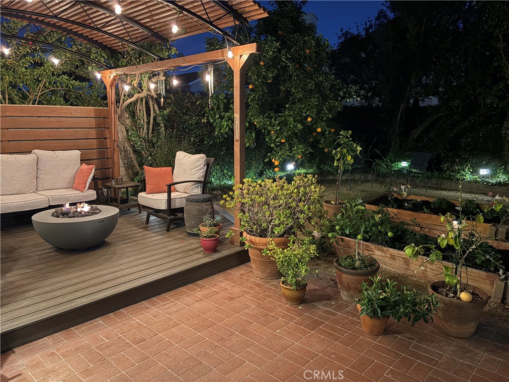5552 Ridgebury Drive Huntington Beach, CA 92649 - Photo 24 of 31 a view of a patio with couple of chairs and a fire pit