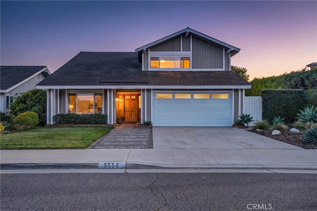 5552 Ridgebury Drive Huntington Beach, CA 92649 - Photo 30 of 31 a front view of a house with a yard and garage