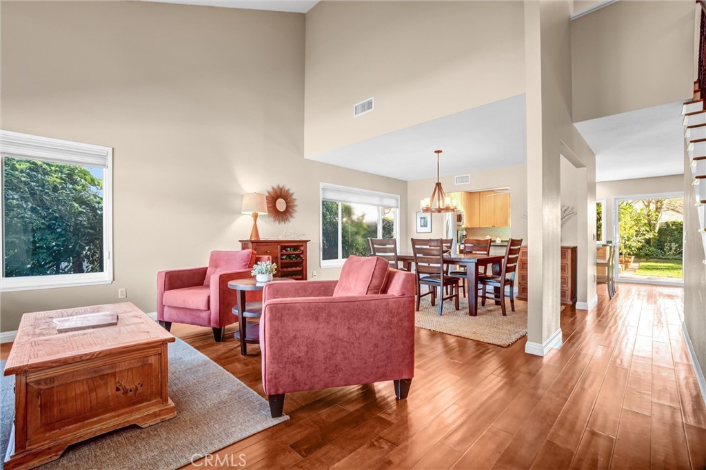 5552 Ridgebury Drive Huntington Beach, CA 92649 - Photo 4 of 31 a living room with furniture a dining table and a large window
