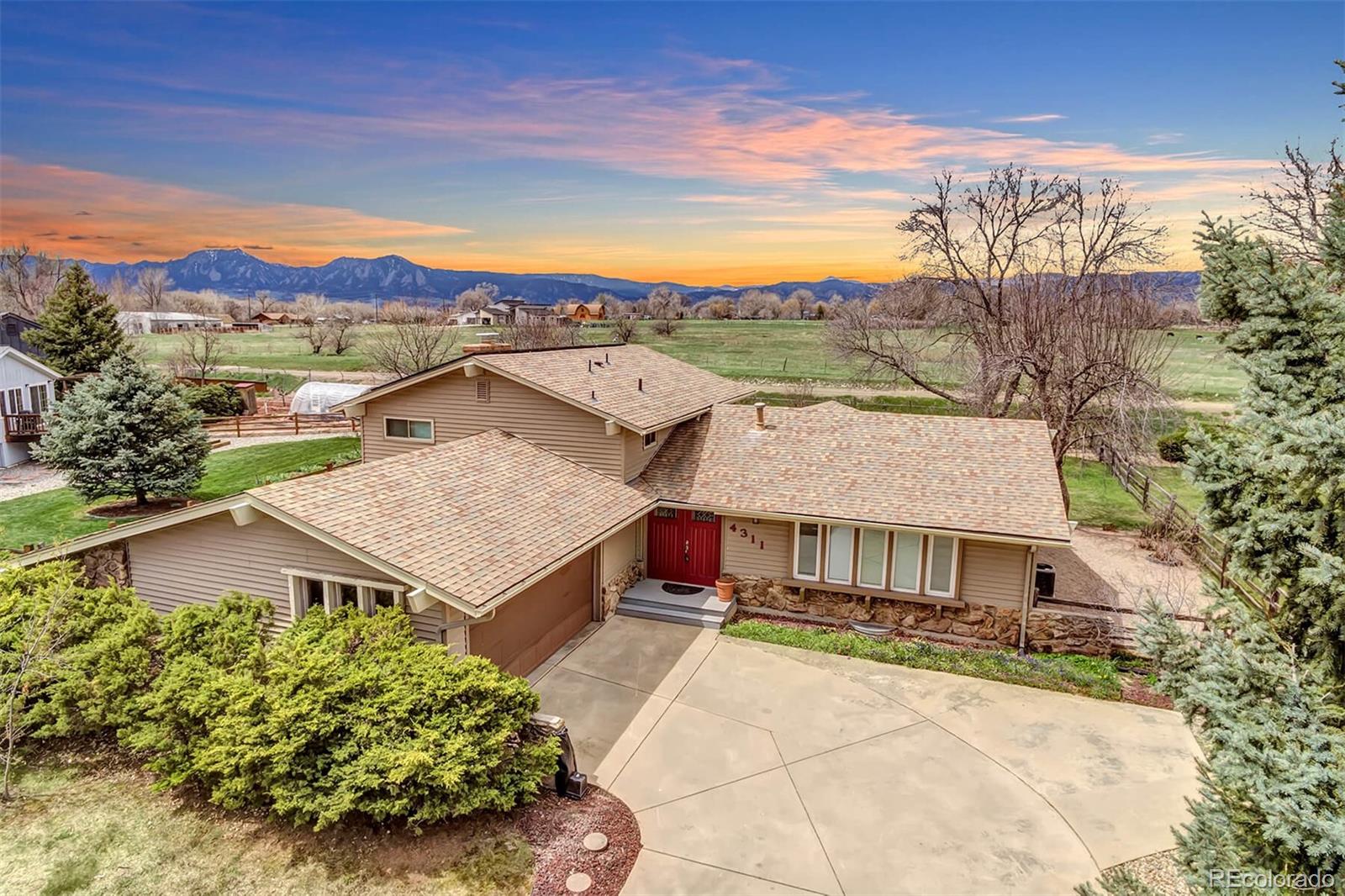 aerial view of a house with a yard and balcony