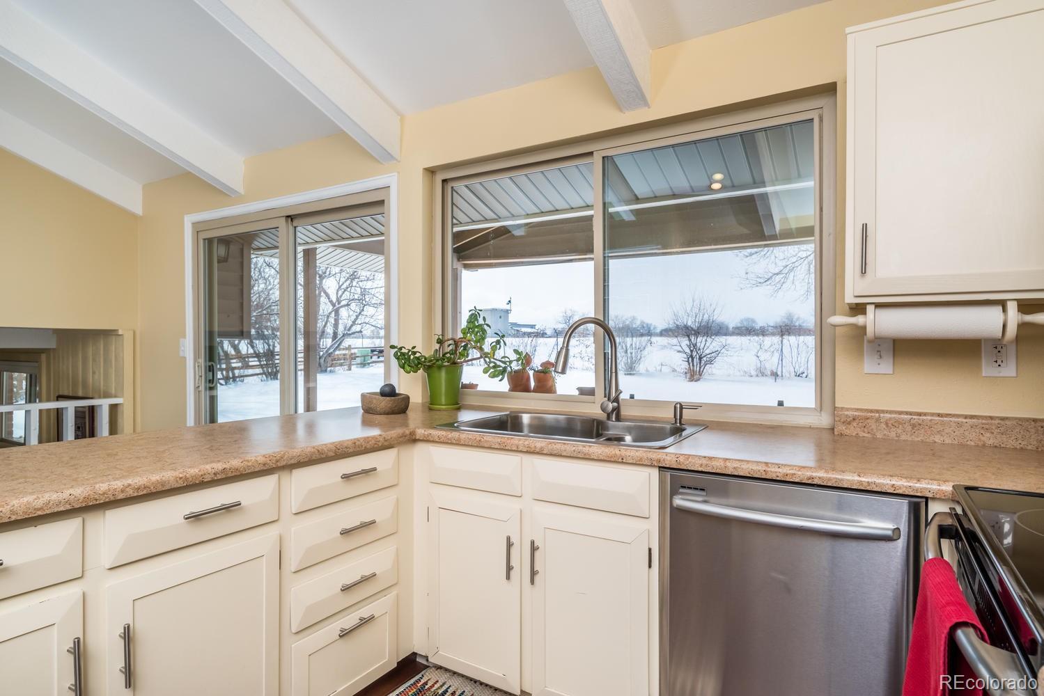4311 Carter Trail Boulder, CO 80301 - Photo 13 of 35 a kitchen with stainless steel appliances granite countertop a sink a stove and cabinets