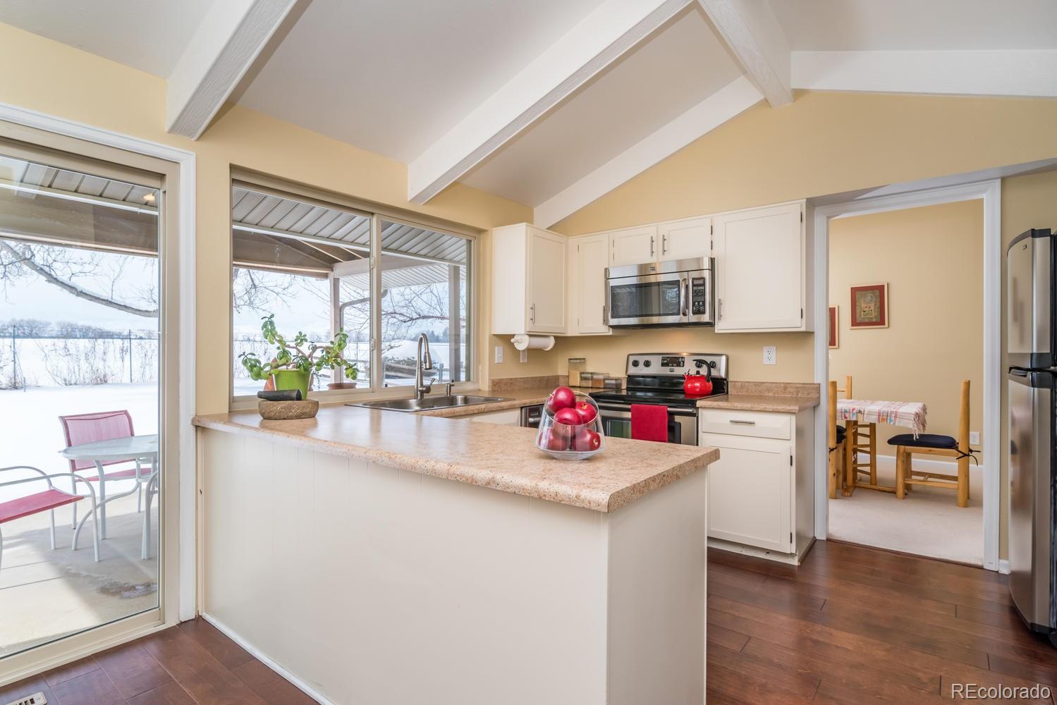 4311 Carter Trail Boulder, CO 80301 - Photo 14 of 35 a kitchen with a sink a counter top space cabinets and stainless steel appliances