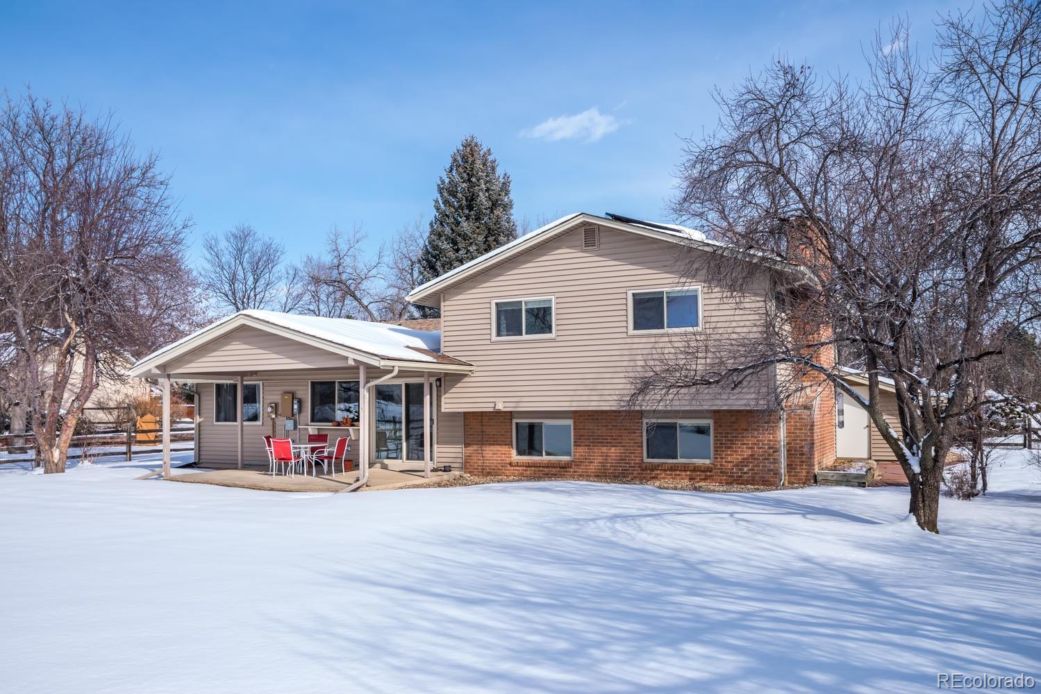 4311 Carter Trail Boulder, CO 80301 - Photo 25 of 35 a front view of a house with large space and large trees