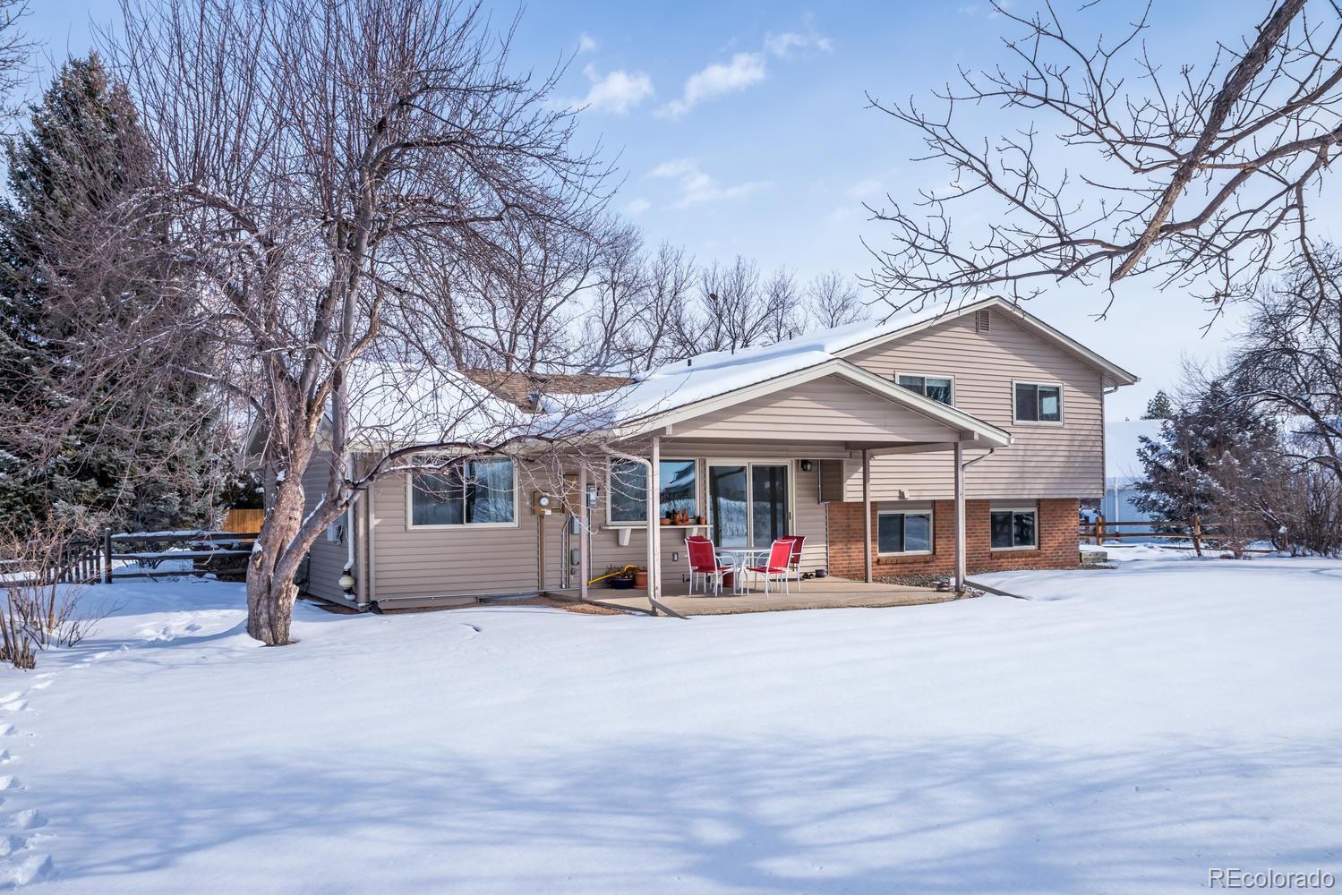 4311 Carter Trail Boulder, CO 80301 - Photo 26 of 35 a front view of a house with a yard covered in snow