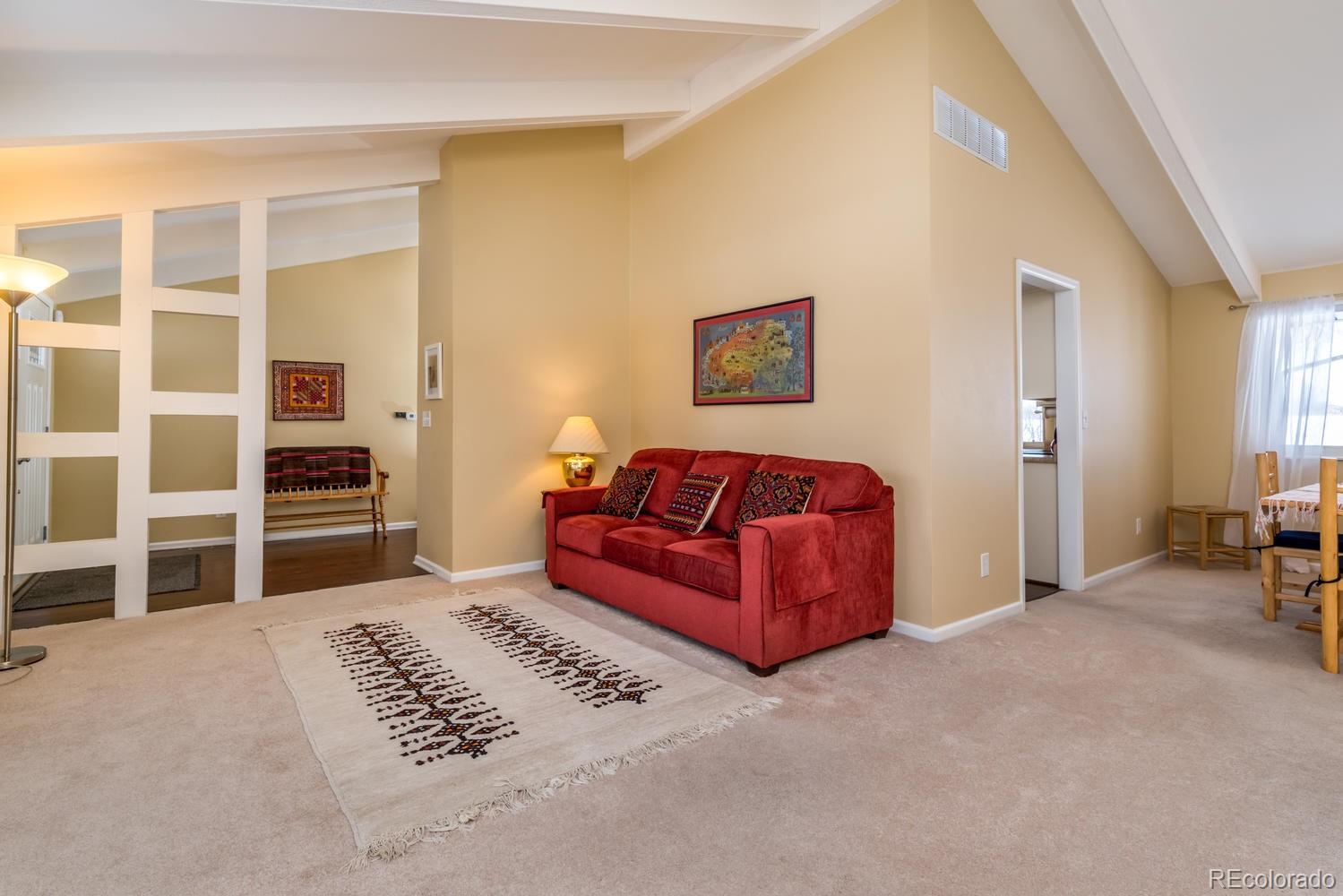 4311 Carter Trail Boulder, CO 80301 - Photo 10 of 35 a living room with furniture a flat screen tv and kitchen view