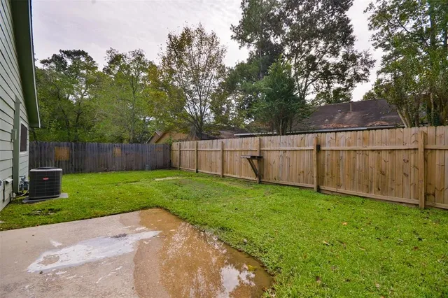 a view of a yard with a fence and trees