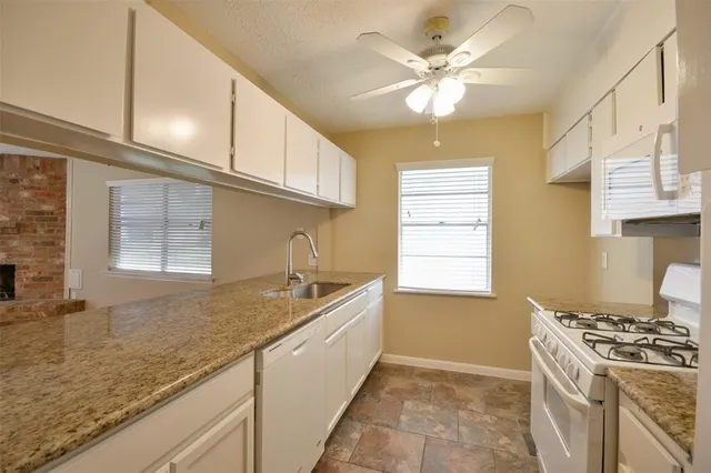 a kitchen with a sink stove and cabinets