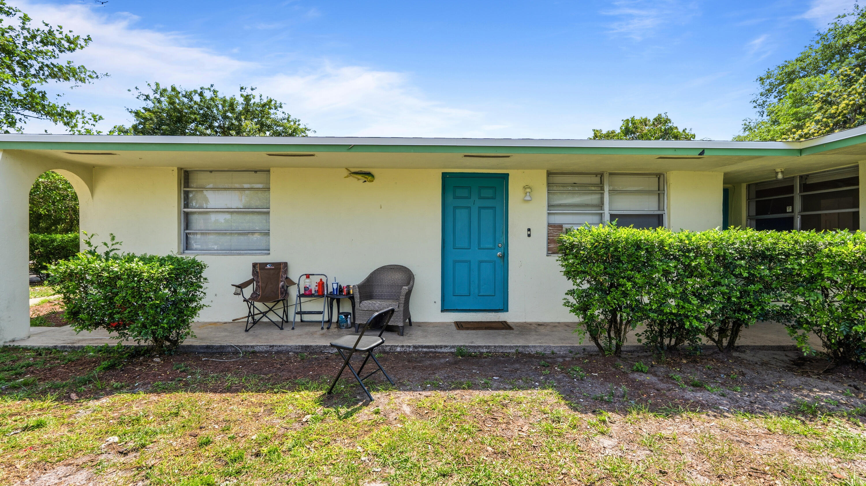 4453 Stevens Road Lake Worth Beach, FL 33461 - Photo 33 of 67 a front view of a house with garden