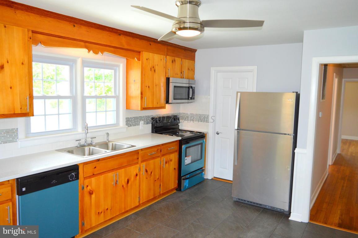 20306 Nanticoke Road Nanticoke, MD 21840 - Photo 2 of 24 a kitchen with granite countertop a refrigerator and a sink