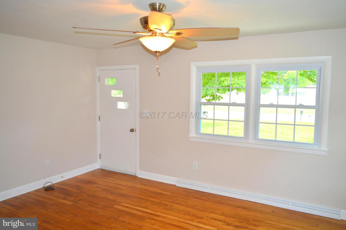 20306 Nanticoke Road Nanticoke, MD 21840 - Photo 12 of 24 a view of an empty room with wooden floor and a window
