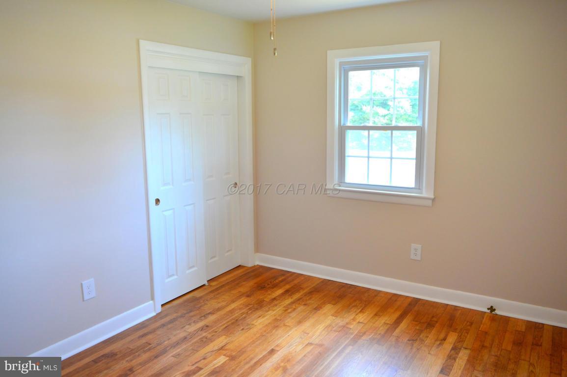 20306 Nanticoke Road Nanticoke, MD 21840 - Photo 17 of 24 an empty room with wooden floor and a window
