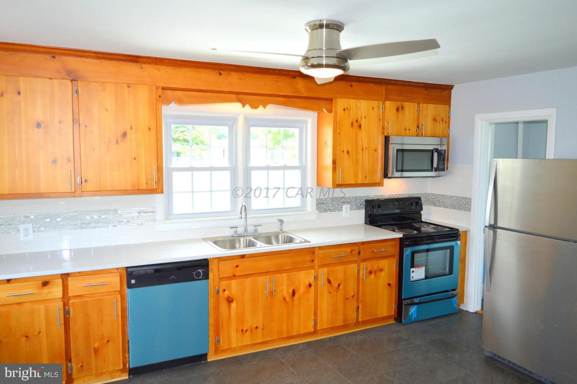 20306 Nanticoke Road Nanticoke, MD 21840 - Photo 6 of 24 a kitchen with stainless steel appliances granite countertop a sink a stove and refrigerator