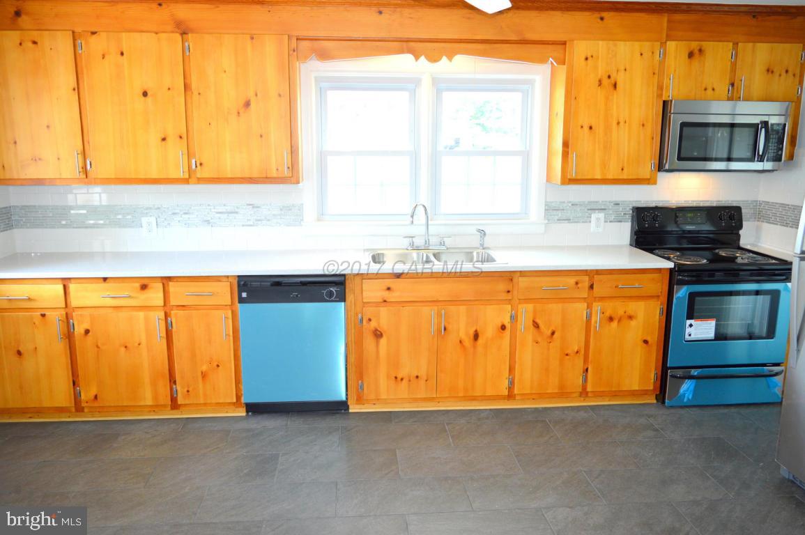 20306 Nanticoke Road Nanticoke, MD 21840 - Photo 7 of 24 a kitchen with a sink and a microwave