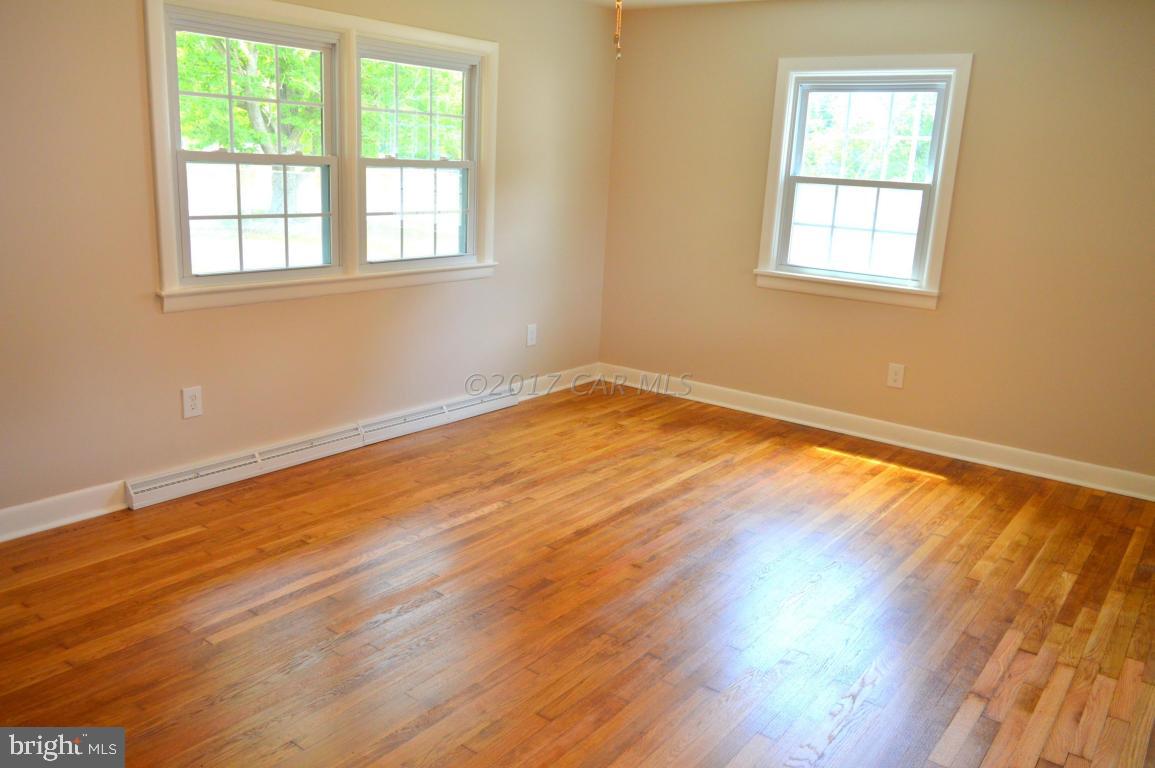 20306 Nanticoke Road Nanticoke, MD 21840 - Photo 8 of 24 an empty room with wooden floor and windows