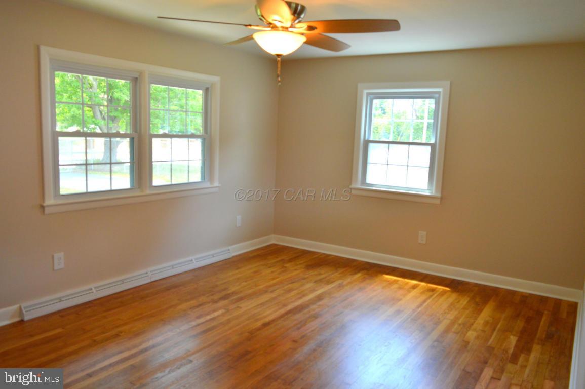 20306 Nanticoke Road Nanticoke, MD 21840 - Photo 9 of 24 a view of an empty room with wooden floor and a window