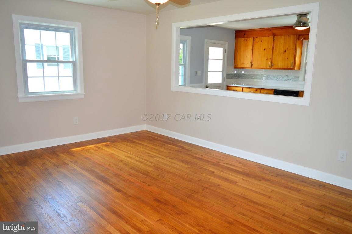 20306 Nanticoke Road Nanticoke, MD 21840 - Photo 10 of 24 an empty room with wooden floor and windows