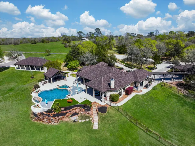 an aerial view of multiple houses with yard