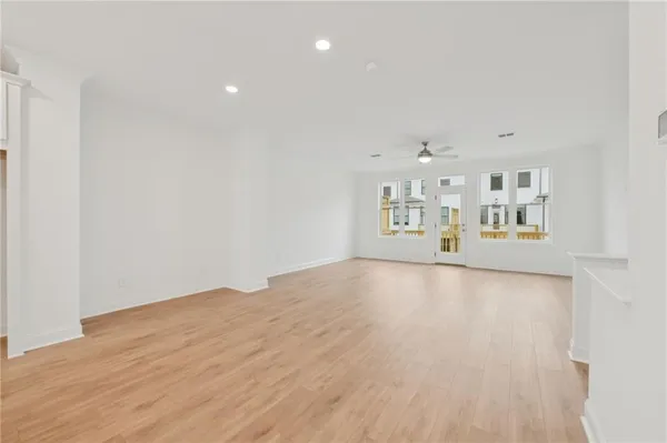 an empty room with closet and windows