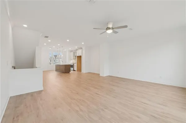 a kitchen with kitchen island a stove a sink a refrigerator and chairs