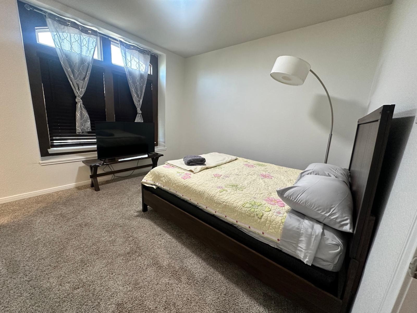 3322 Harvest Meadow Lane Rosenberg, TX 77471 - Photo 20 of 39 a bedroom with a bed and painting on the wall