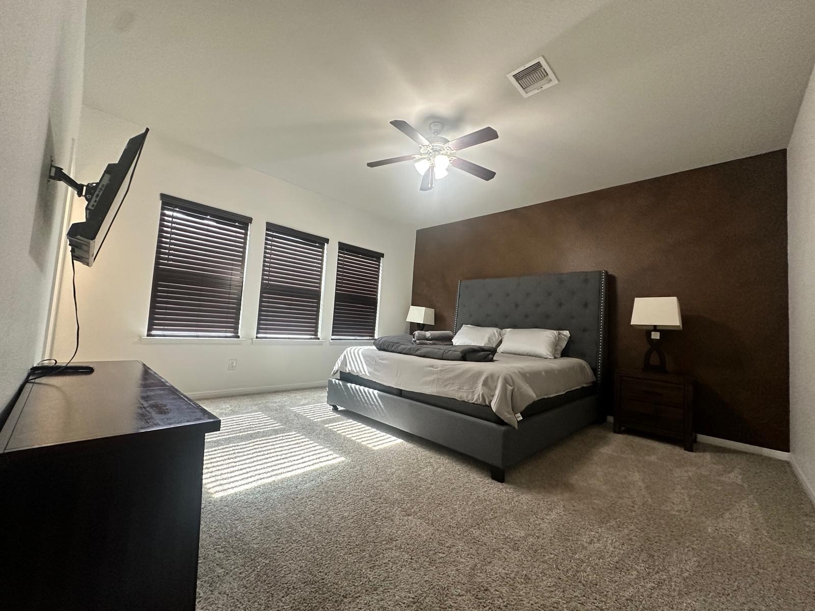 3322 Harvest Meadow Lane Rosenberg, TX 77471 - Photo 21 of 39 a spacious bedroom with a bed and a chandelier