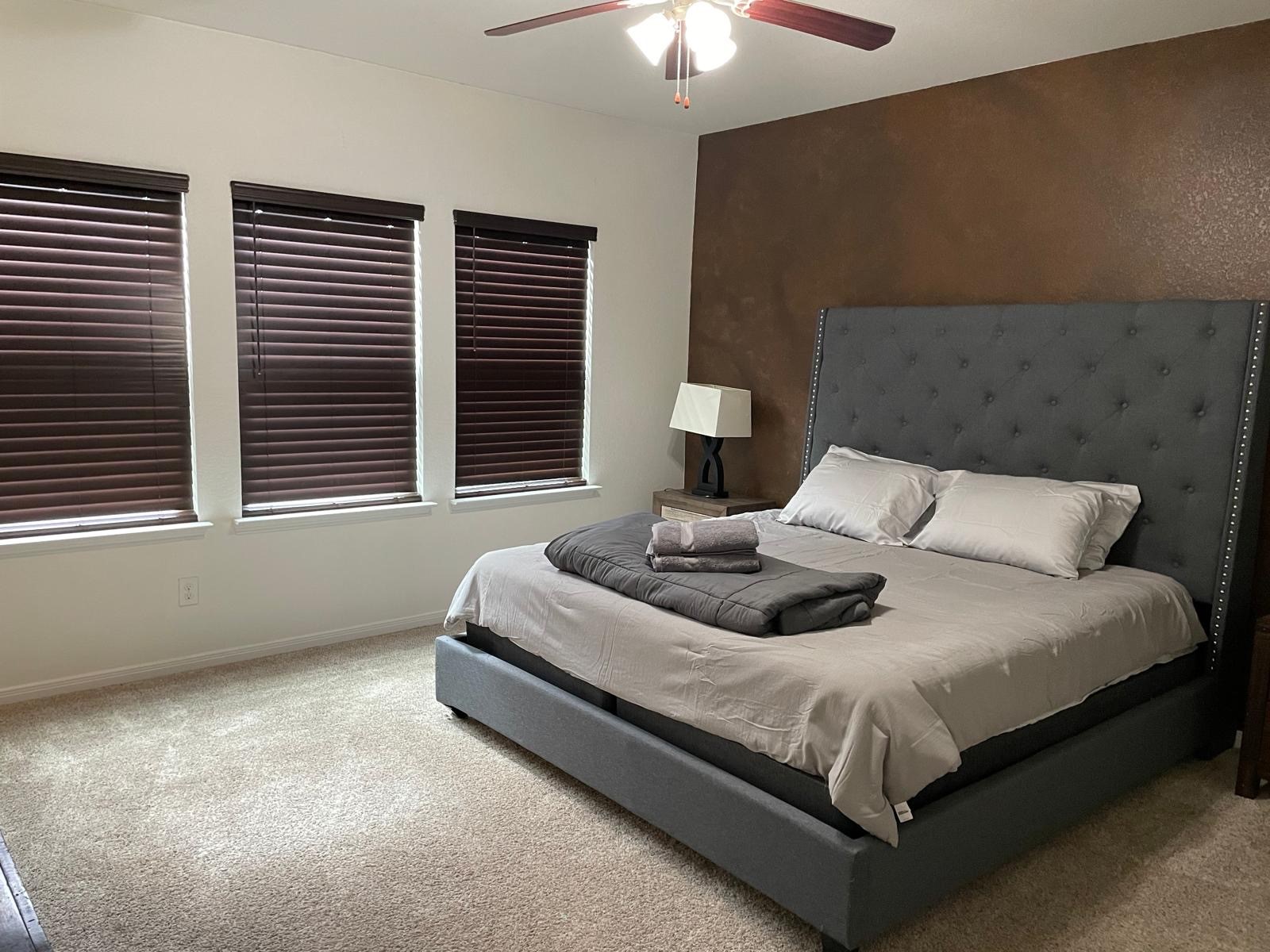 3322 Harvest Meadow Lane Rosenberg, TX 77471 - Photo 37 of 39 a bedroom with a bed and a chandelier