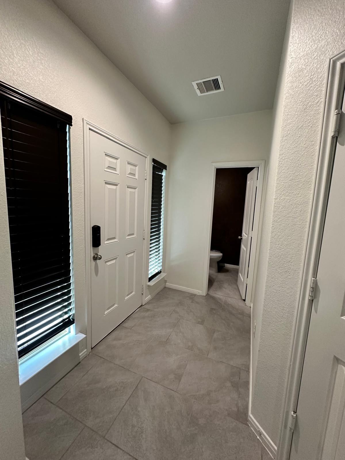 3322 Harvest Meadow Lane Rosenberg, TX 77471 - Photo 9 of 39 a view of a livingroom with an empty space and a hallway