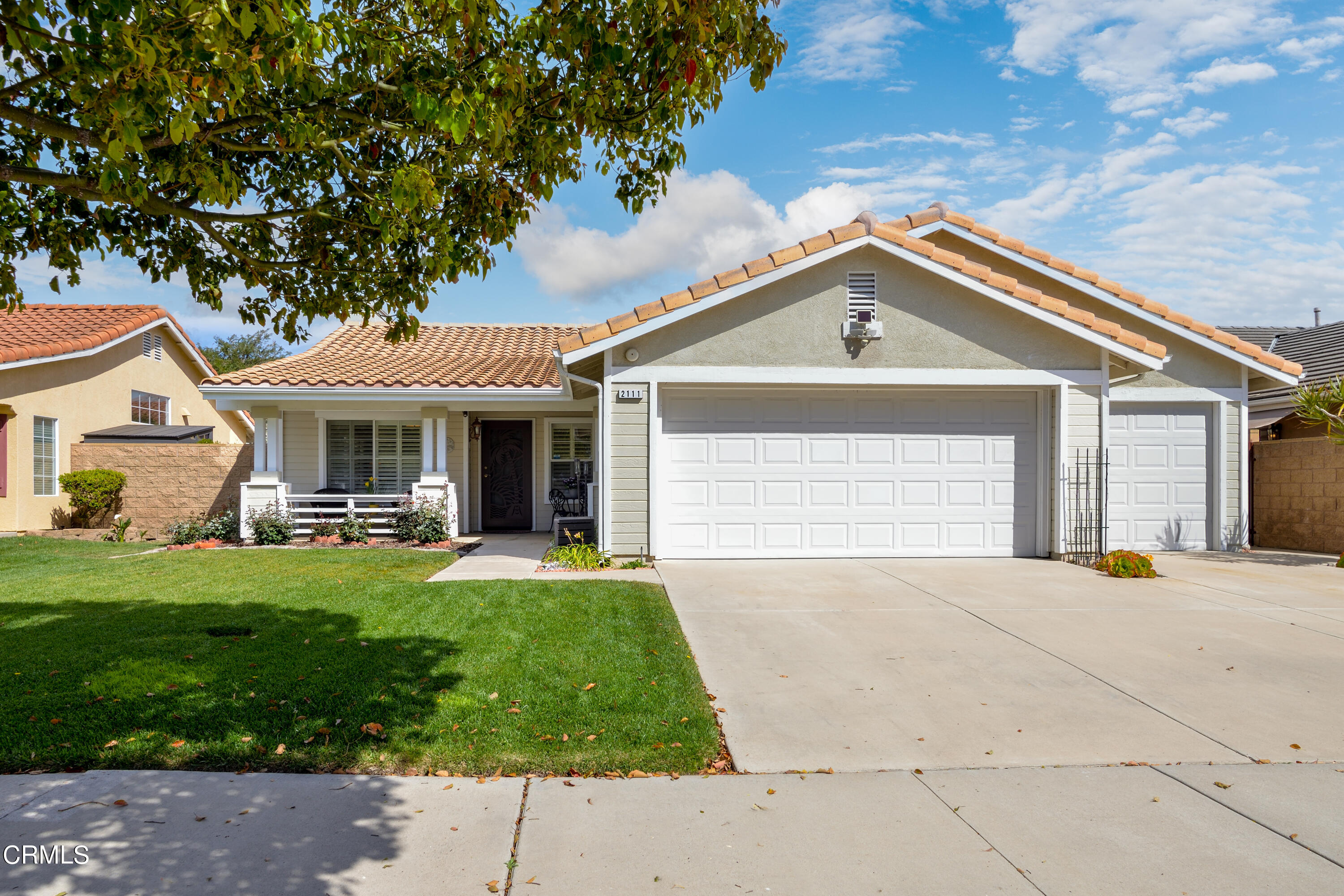 a front view of a house with a garden and porch