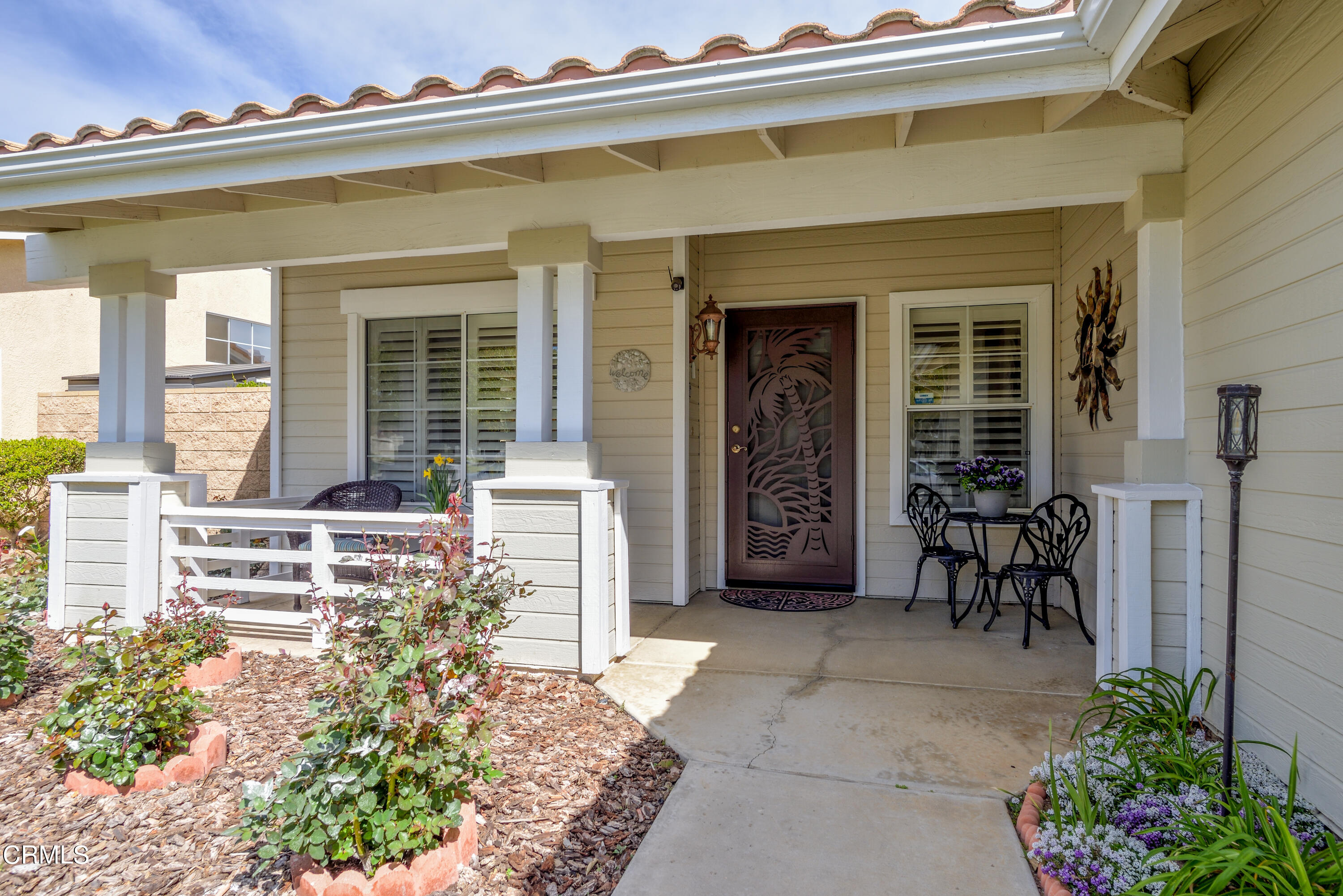 2111 Orlop Place Oxnard, CA 93035 - Photo 2 of 26 front view of a house with a chairs and table in a patio