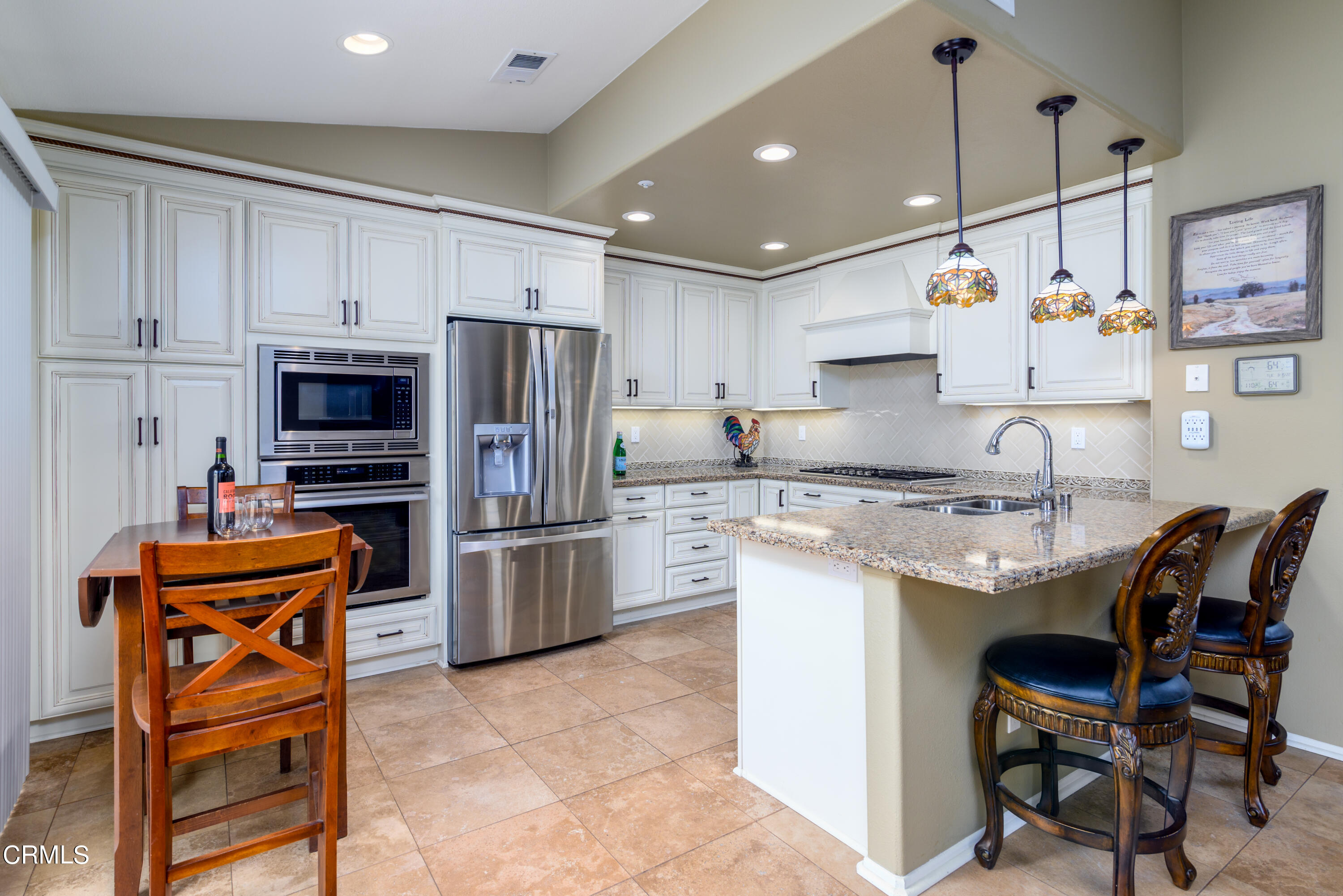 2111 Orlop Place Oxnard, CA 93035 - Photo 5 of 26 a kitchen with stainless steel appliances granite countertop a sink stove and refrigerator