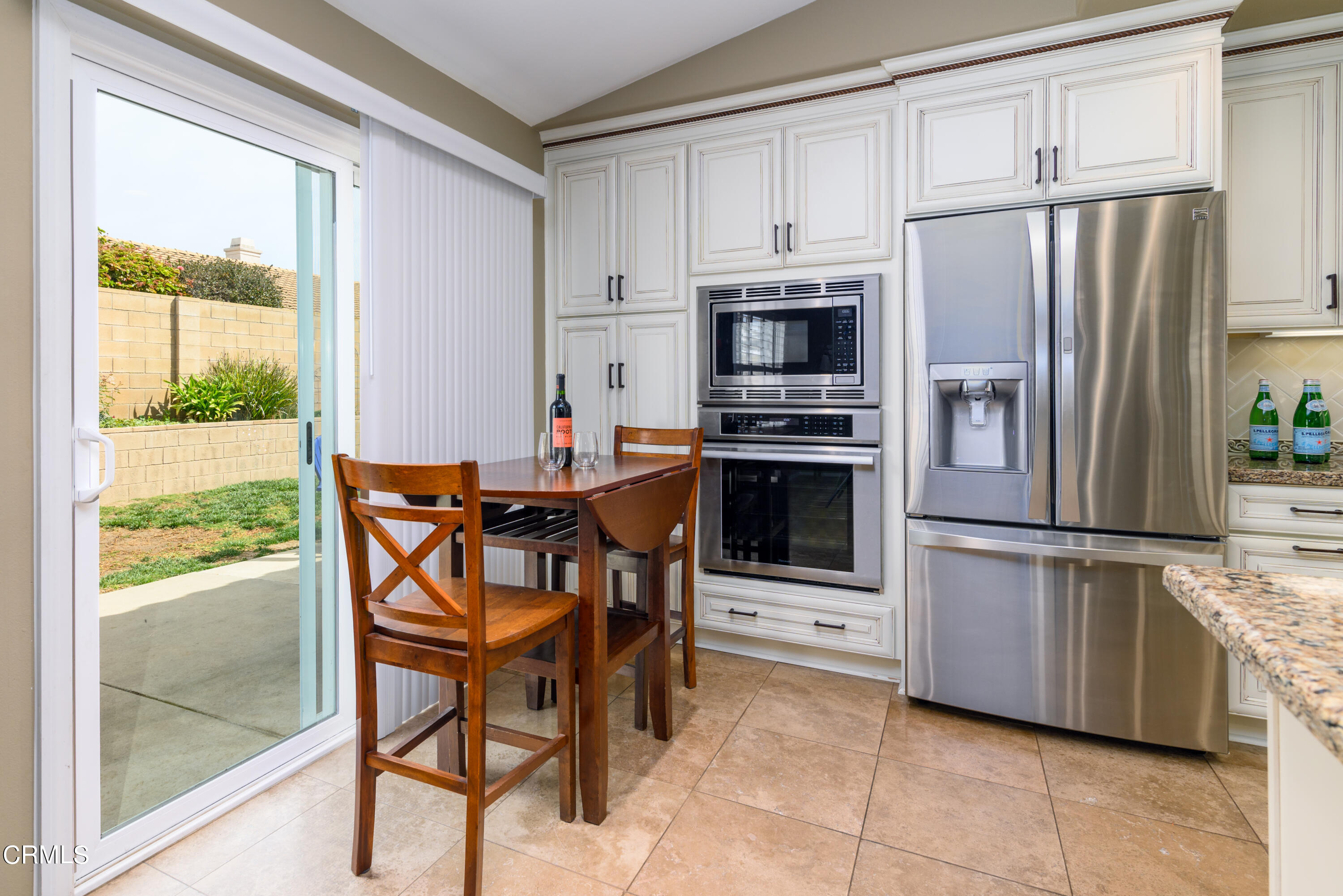 2111 Orlop Place Oxnard, CA 93035 - Photo 6 of 26 a kitchen with stainless steel appliances a refrigerator a stove a microwave and a dining table