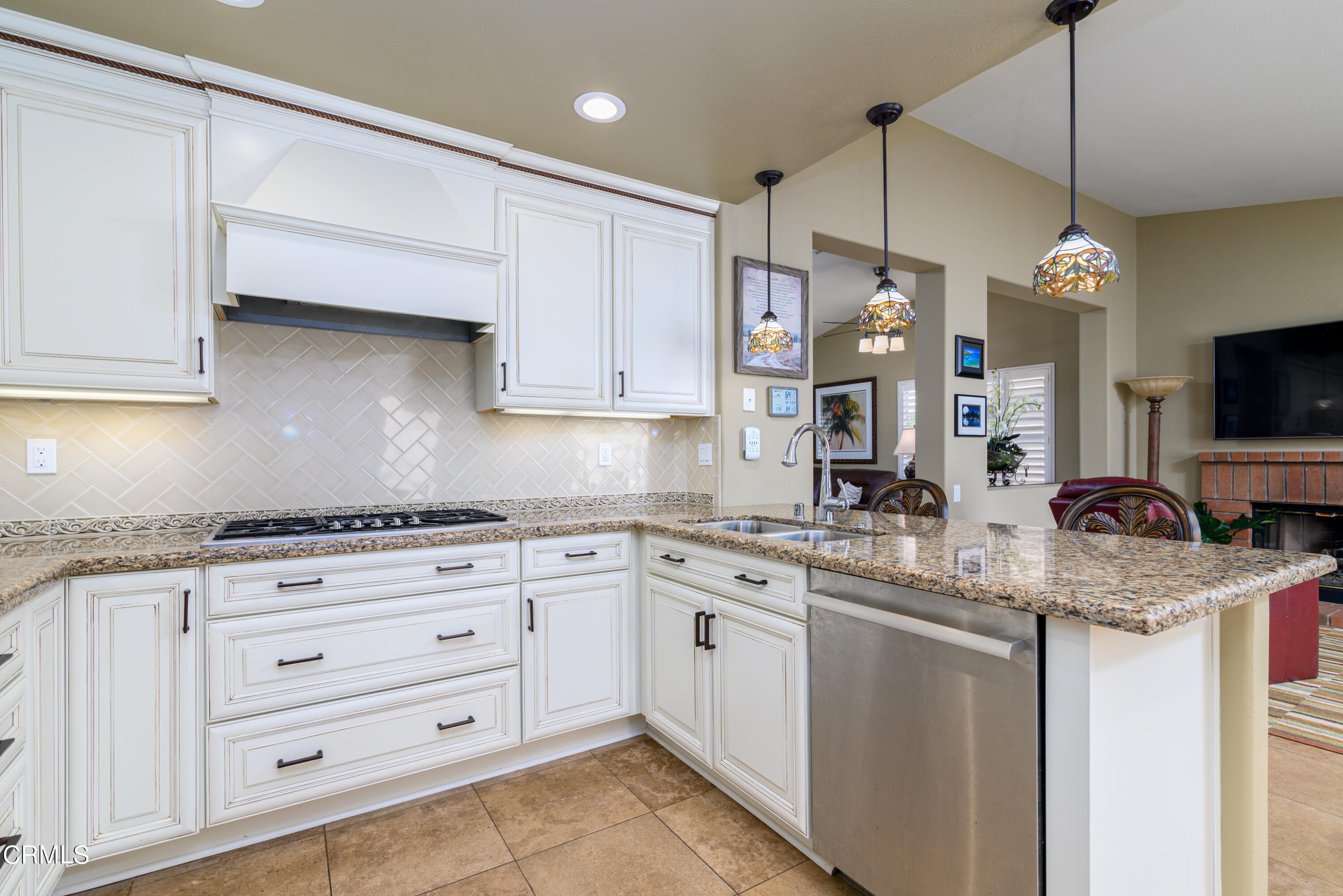 2111 Orlop Place Oxnard, CA 93035 - Photo 8 of 26 a kitchen with stainless steel appliances granite countertop a sink a stove and a microwave