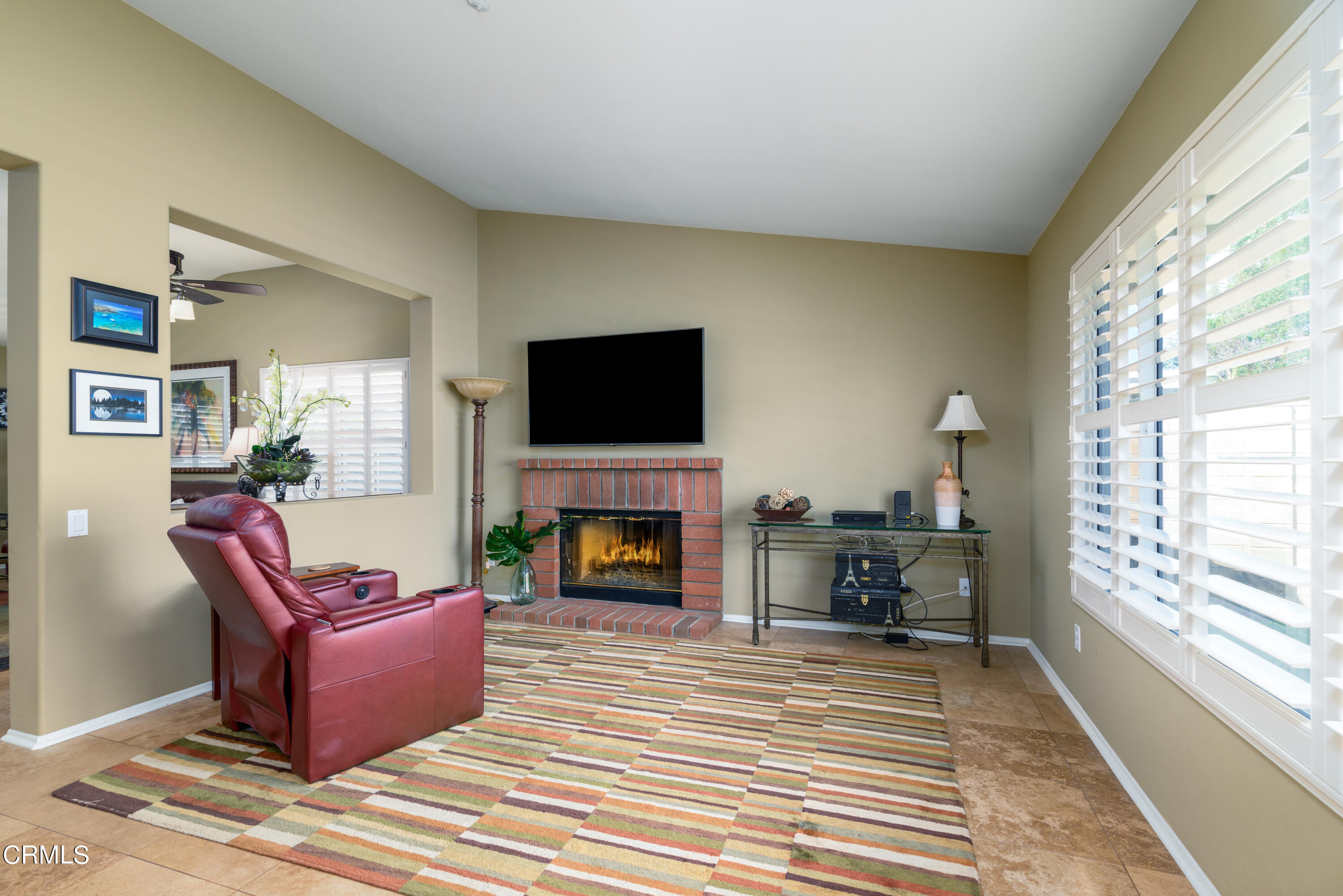 2111 Orlop Place Oxnard, CA 93035 - Photo 9 of 26 a living room with furniture a flat screen tv and a fireplace