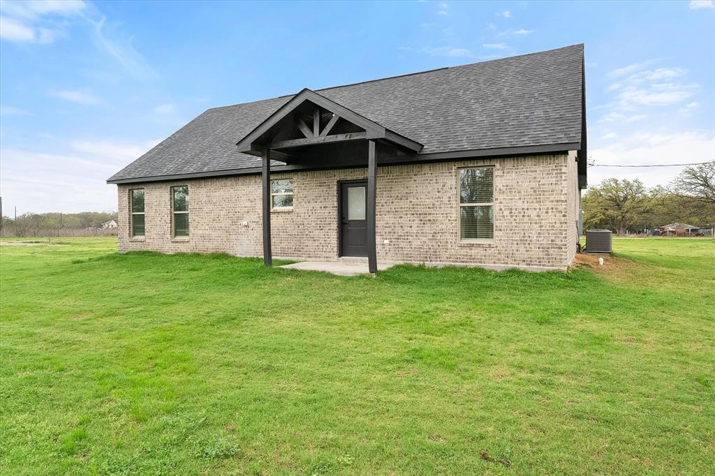 6771 Northwest County Road 1146 Barry, TX 75102 - Photo 30 of 34 a front view of a house with garden