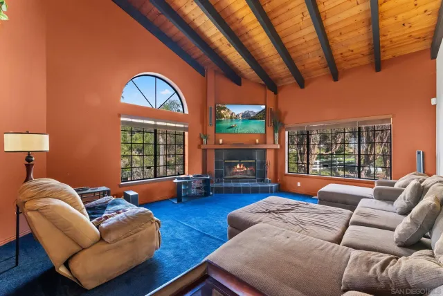 a kitchen with stainless steel appliances a table chairs and a refrigerator