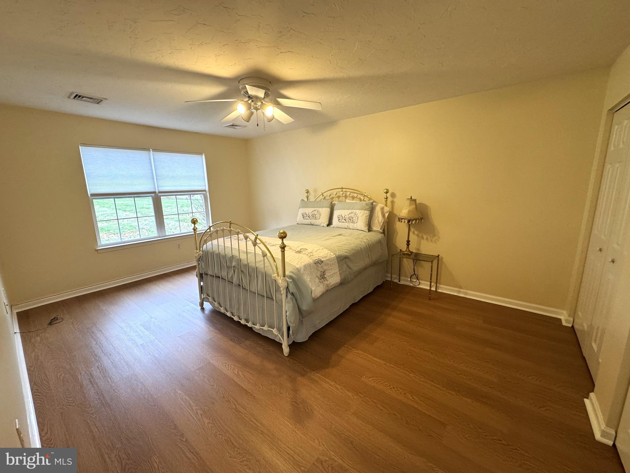 6746 Seneca Ridge Drive York, PA 17403 - Photo 14 of 19 a spacious bedroom with a bed chandelier and a window
