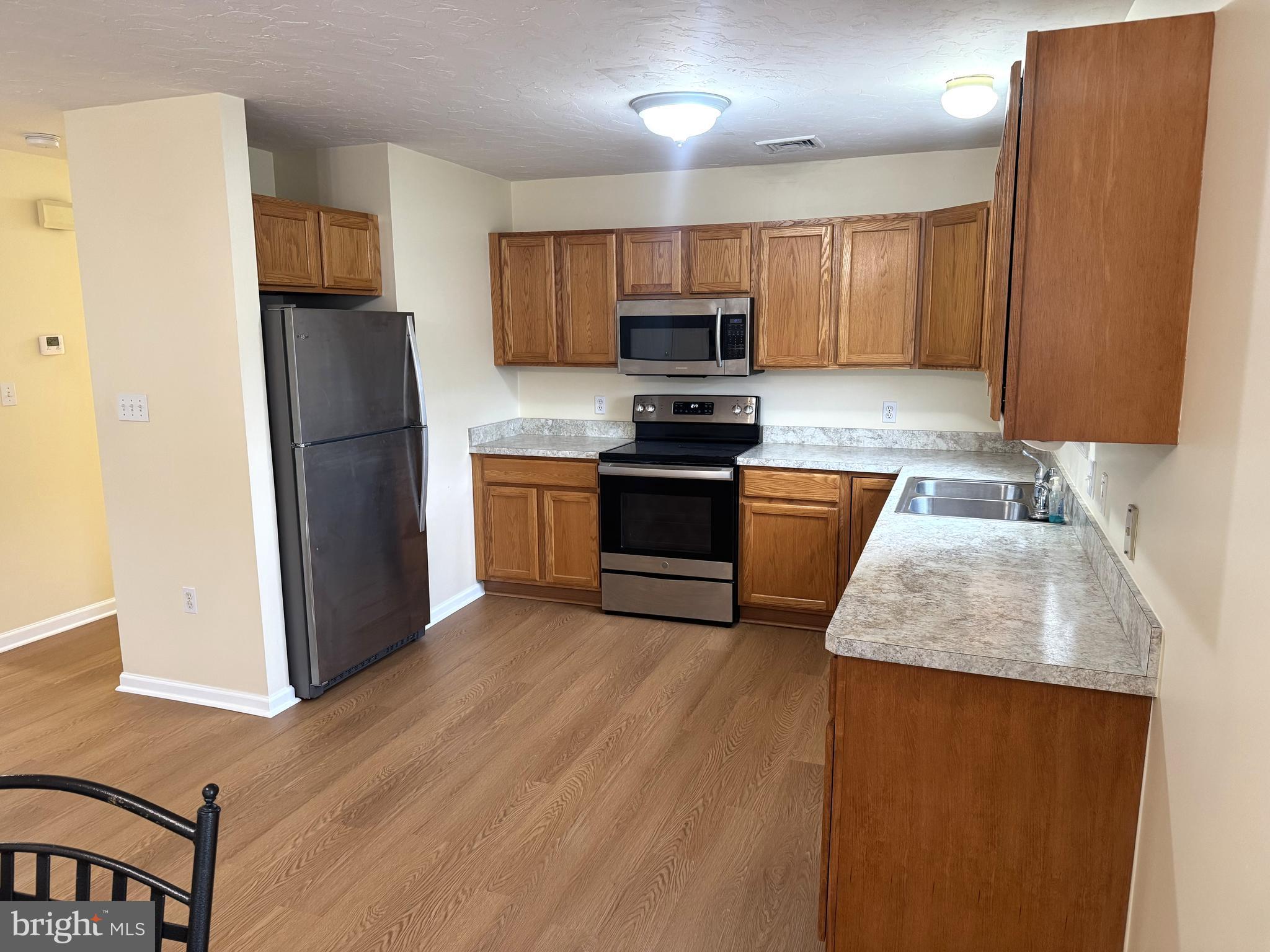 6746 Seneca Ridge Drive York, PA 17403 - Photo 4 of 19 a kitchen with stainless steel appliances granite countertop a refrigerator a stove top oven a sink and dishwasher