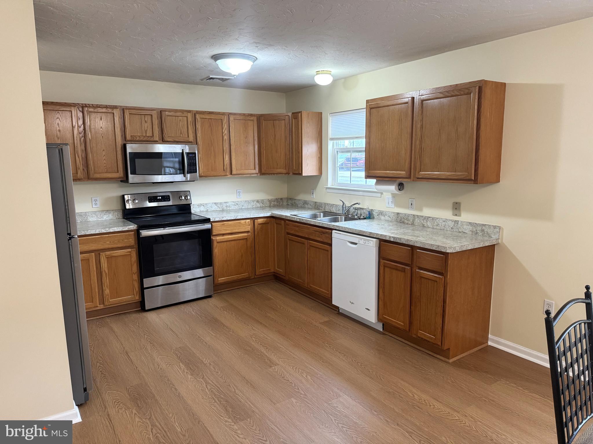 6746 Seneca Ridge Drive York, PA 17403 - Photo 5 of 19 a kitchen with stainless steel appliances granite countertop wooden cabinets a stove top oven a sink and dishwasher