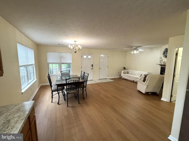 a dining room with furniture and wooden floor