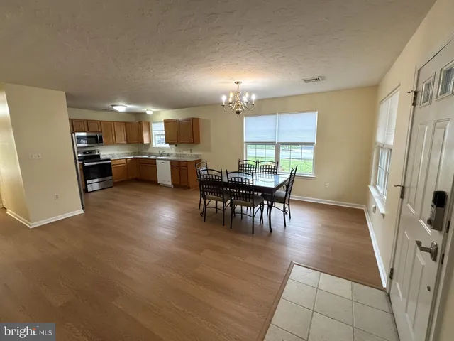 a kitchen with a table and chairs in it