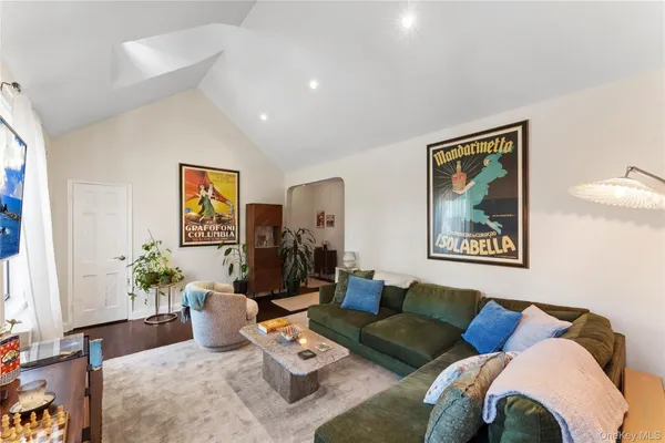 a living room with furniture and painting on the wall